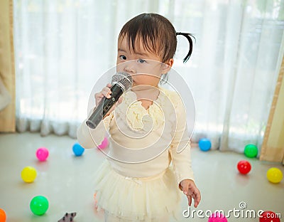 Little asian girl with microphone Stock Photo