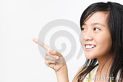 Little Asian girl pointing away Stock Photo