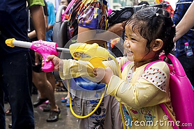 Little Asian Girl Shooting Water Gun at Songkran Festival in Ban Editorial Stock Photo