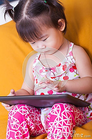 Little asian girl using digital tablet, child finger point at co Stock Photo