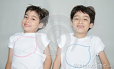 Little asian sibling boy laying down Stock Photo