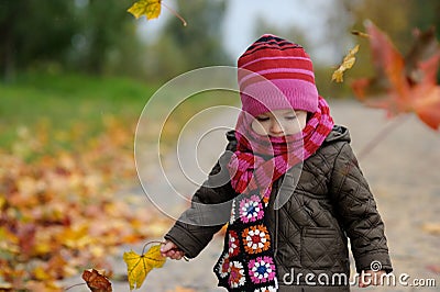 Little baby in an autumn park Stock Photo