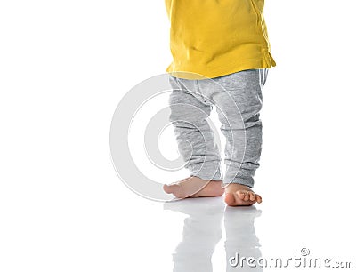 Little baby barefoot leg on white wall background Stock Photo
