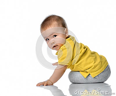 Little baby boy on floor looking over shoulder Stock Photo