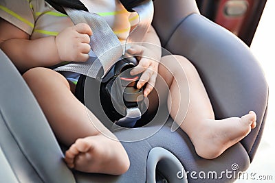 Little baby in child safety seat inside of car Stock Photo