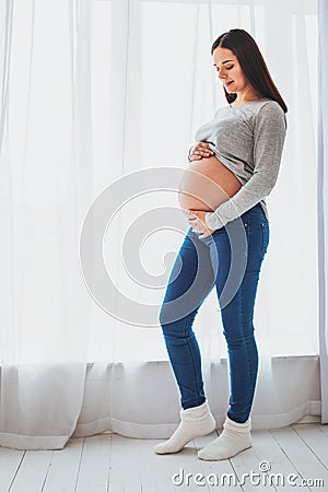 Dark-haired pretty woman expecting little baby Stock Photo