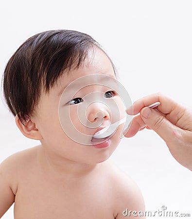 Little baby feeding with a spoon Stock Photo