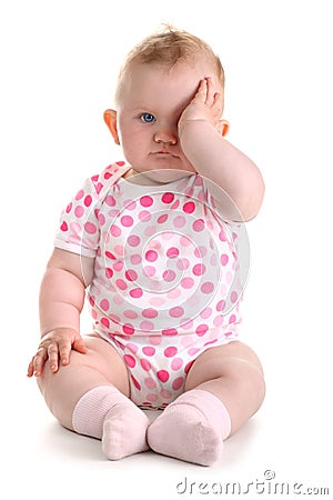 Little baby girl covers her eye with left hand iso Stock Photo