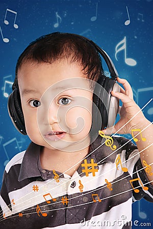 Little baby listening to music Stock Photo