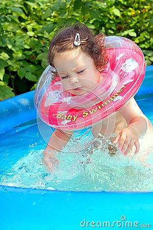 Little baby splashing in waterpool Stock Photo