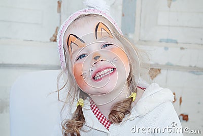 Little beautiful girl with face painting of fox smiles Stock Photo