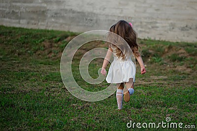 Little beautiful running girl outside Stock Photo