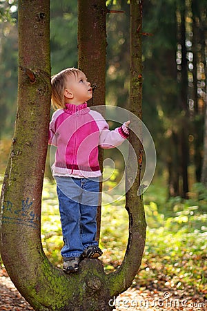 Little beauty girl on tree Stock Photo