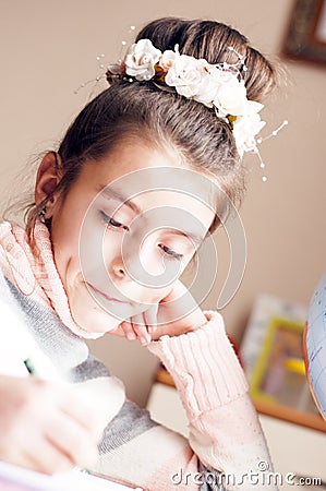 Little beautyful girl draws sitting table in room Stock Photo