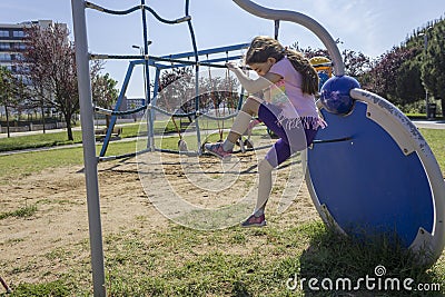 Little beginner school girl playing at playground Stock Photo
