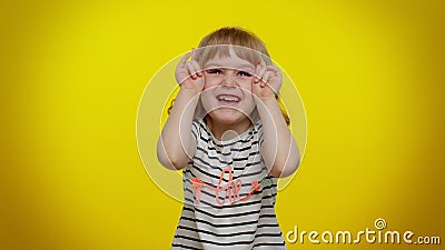 Little bit crazy funny kid child demonstrating tongue out, fooling around making silly faces madness Stock Photo