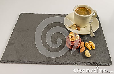 The little black coffee with nut muffin, walnuts, almonds and ca Stock Photo