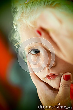 Little blond blue eyed girl face painting Stock Photo