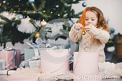 Little blonde baby girl helping decorate Stock Photo