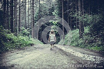 Little Girl Lost in Forest Walking Alone Stock Photo