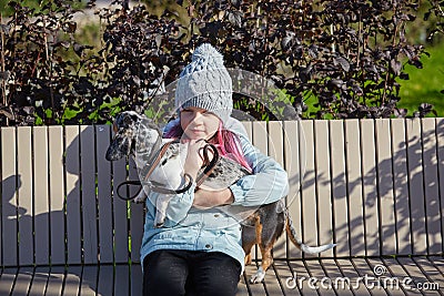 Little blonde girl and a loving puppy dachshund Stock Photo