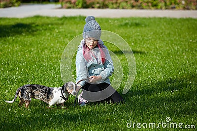 Little blonde girl and a loving puppy dachshund Stock Photo