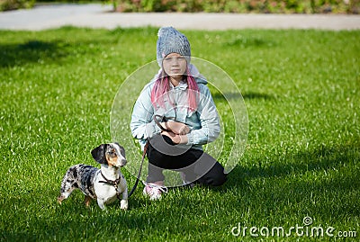 Little blonde girl and a loving puppy dachshund Stock Photo