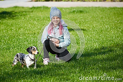 Little blonde girl and a loving puppy dachshund Stock Photo