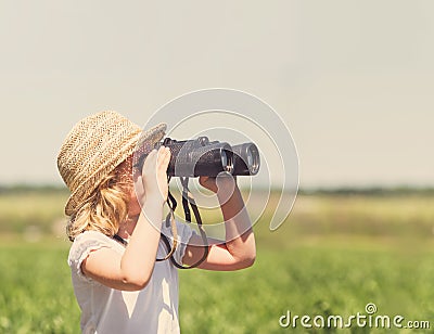 Little blonde girl in straw hat Stock Photo