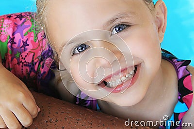 Little Blonde Girl Swimming in Pool in Summer Stock Photo