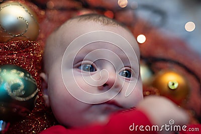 Little blue eyed baby lying in a Christmas cot Stock Photo