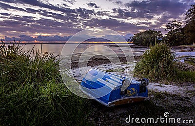 The little blue rowboat on the shore Stock Photo