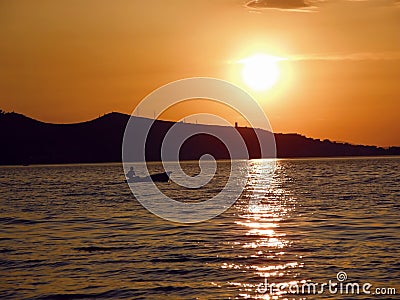 Little boat in golden sunset Stock Photo