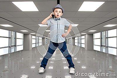 Little boss talks on his mobile phone.Emotional conversation.A great bargain at the Mall. Stock Photo