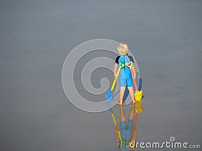 Little boy at beach standing tall Stock Photo