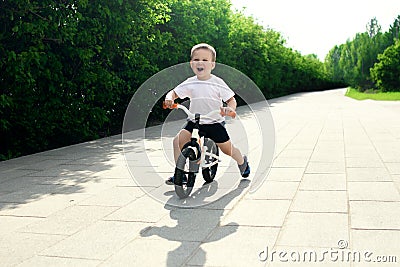 Little boy on a bicycle. Caught in motion, on a driveway. Presch Stock Photo