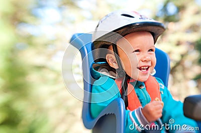 Little boy in bike child seat happy Stock Photo