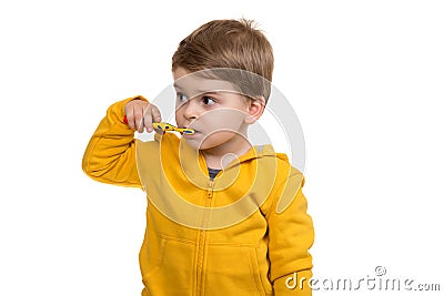 Little Boy Brushing Teeth on white background Stock Photo