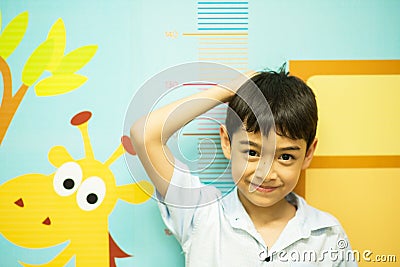 Little boy checking his height at hospital growing up Stock Photo
