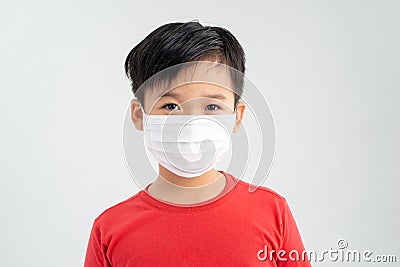 Little boy, a child in a medical mask on a white background. The concept of an epidemic, influenza, protection from disease, Stock Photo