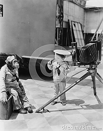 Little boy with chimpanzee taking pictures Stock Photo