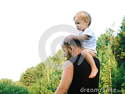 A little boy climbed onto his father`s shoulder Stock Photo