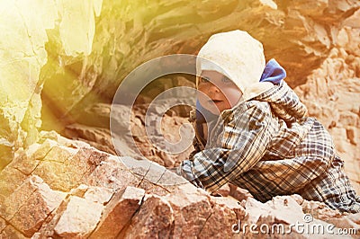 Baby climbing on a rock Stock Photo