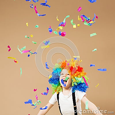 Little boy in clown wig jumping and having fun celebrating birth Stock Photo