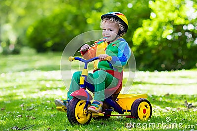 Little boy on colorful tricycle Stock Photo