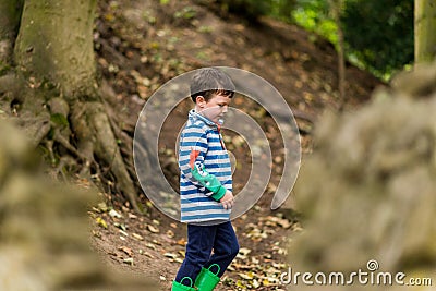 A small boy has an adventure through a forest Stock Photo