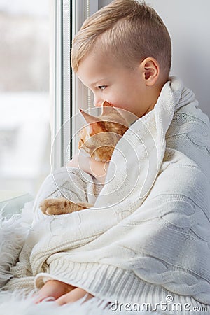 Little boy with cute cat at home Stock Photo