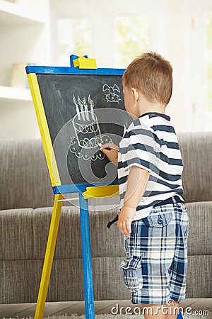 Little boy drawing on blackboard Stock Photo