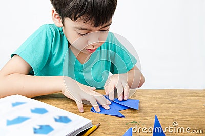 Little boy drawing on paper art origami Stock Photo