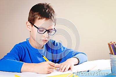 Little boy draws with color pencils and felt pens Stock Photo